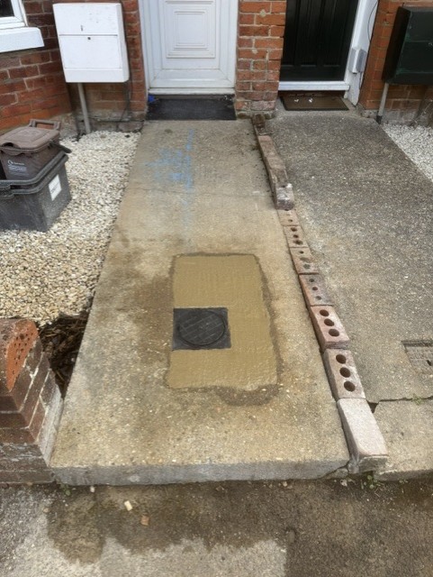 Concrete path neatly reinstated around a new boundary box cover