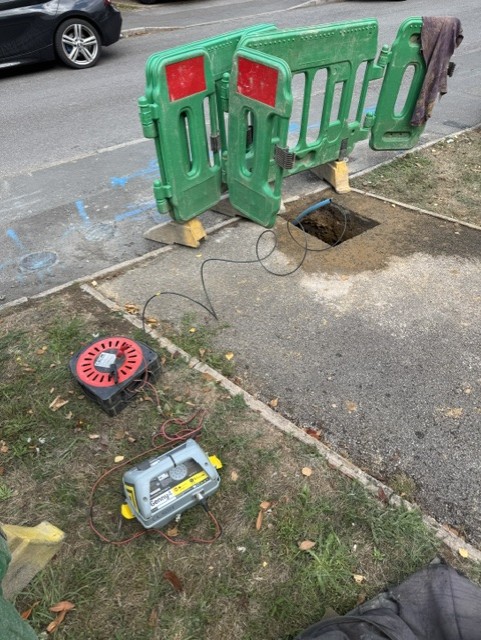 Excavation at a property boundary protected by safety barriers