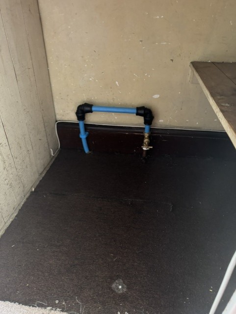 New blue supply pipe brought inside with a stopcock fitted