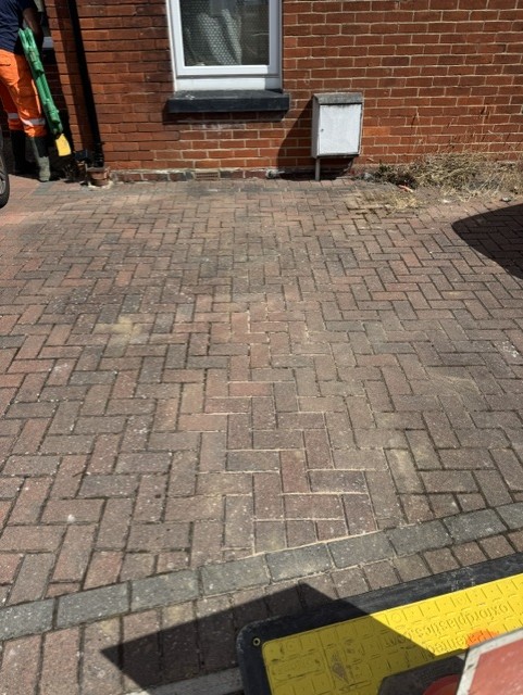 Block paved driveway neatly relaid after supply pipe work